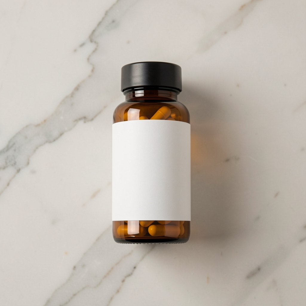 Amber glass vitamin supplement bottle on a pale marble surface, minimal overhead editorial shot
